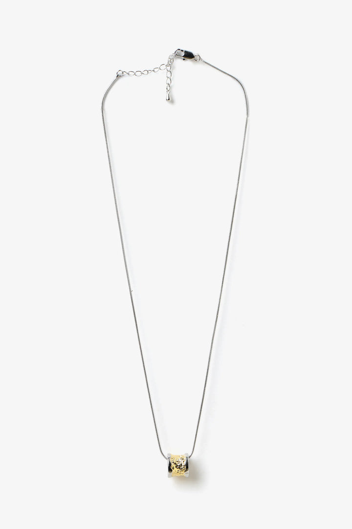 Core Form pendant necklace with textured gold core and minimal silver chain