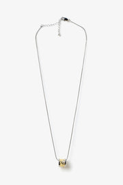 Core Form pendant necklace with textured gold core and minimal silver chain