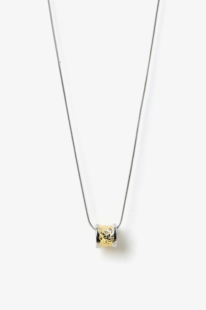 Core Form pendant necklace with textured gold core and minimal silver chain