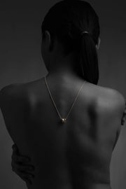Core Form pendant necklace with textured gold core and minimal silver chain