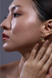 crust form hoop earrings with textured raw surface and gold hoop design