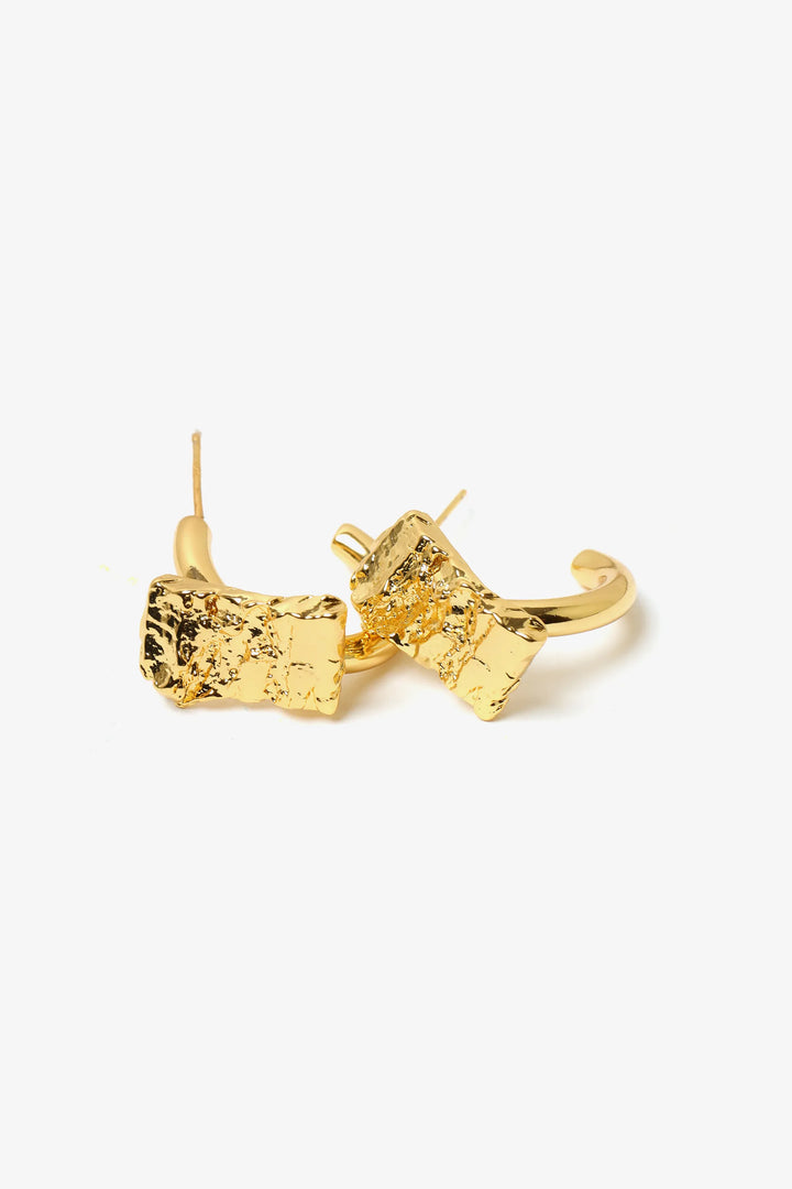 crust form hoop earrings with textured raw surface and gold hoop design