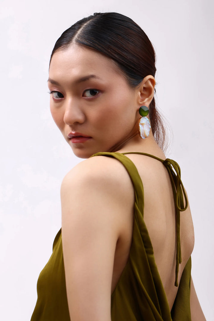 Model wearing Min & Lith Iridescent Ore Drop Earrings, featuring olive-green faceted studs and luminous peach-toned drops with an iridescent finish.