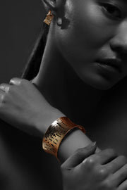 Textured relief cuff bracelet in gold with sculptural open form
