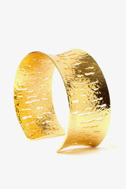 Textured relief cuff bracelet in gold with sculptural open form