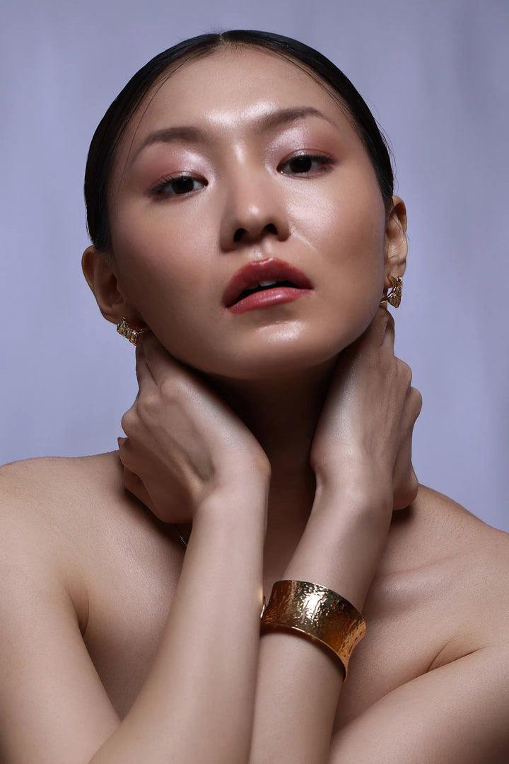 Textured relief cuff bracelet in gold with sculptural open form