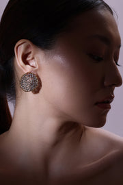 woven element stud earrings with mesh texture and circular sculptural design