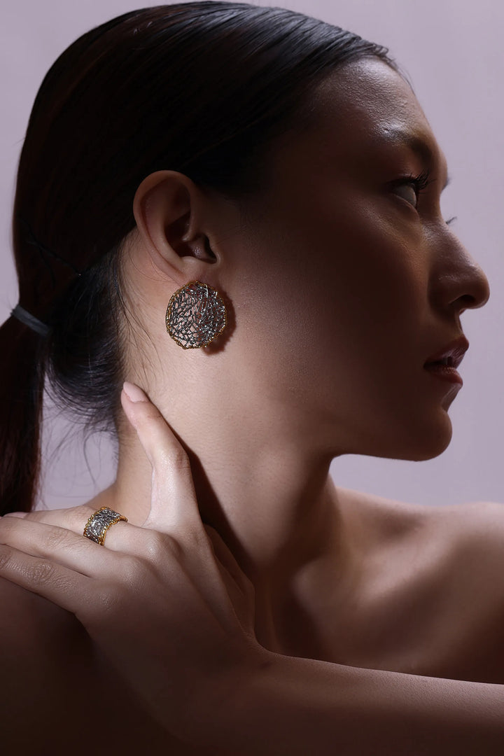 woven element stud earrings with mesh texture and circular sculptural design